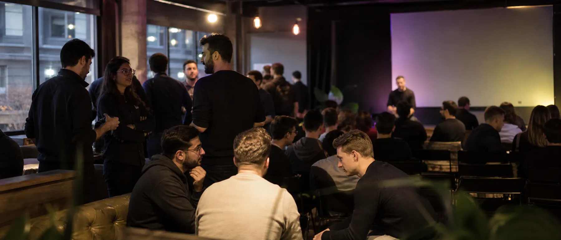 Spark AI Showcase Night venue lit in deep purple and yellow ambient lighting